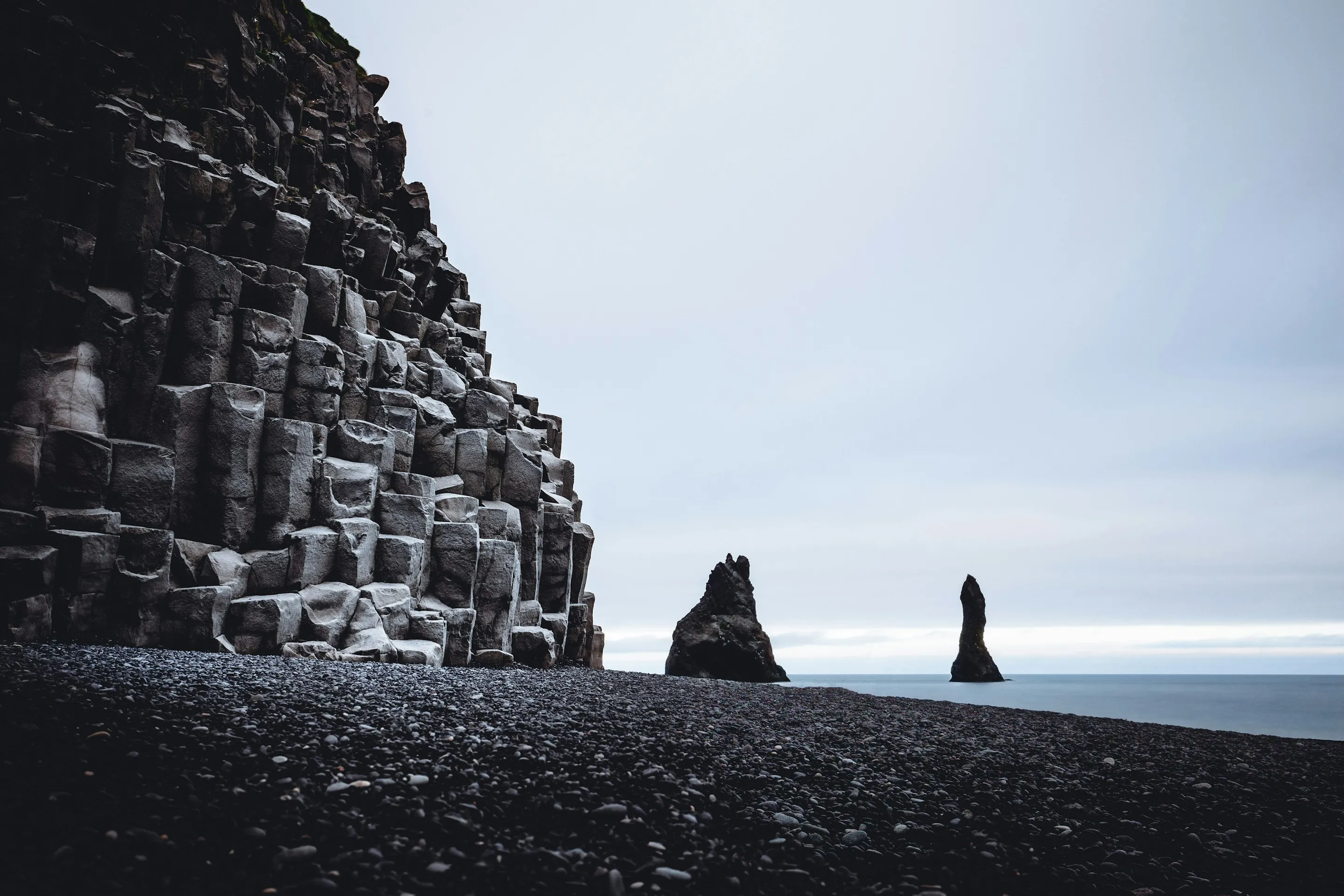 Basalt columns and sea stacks on the black sand at Reynisfjara