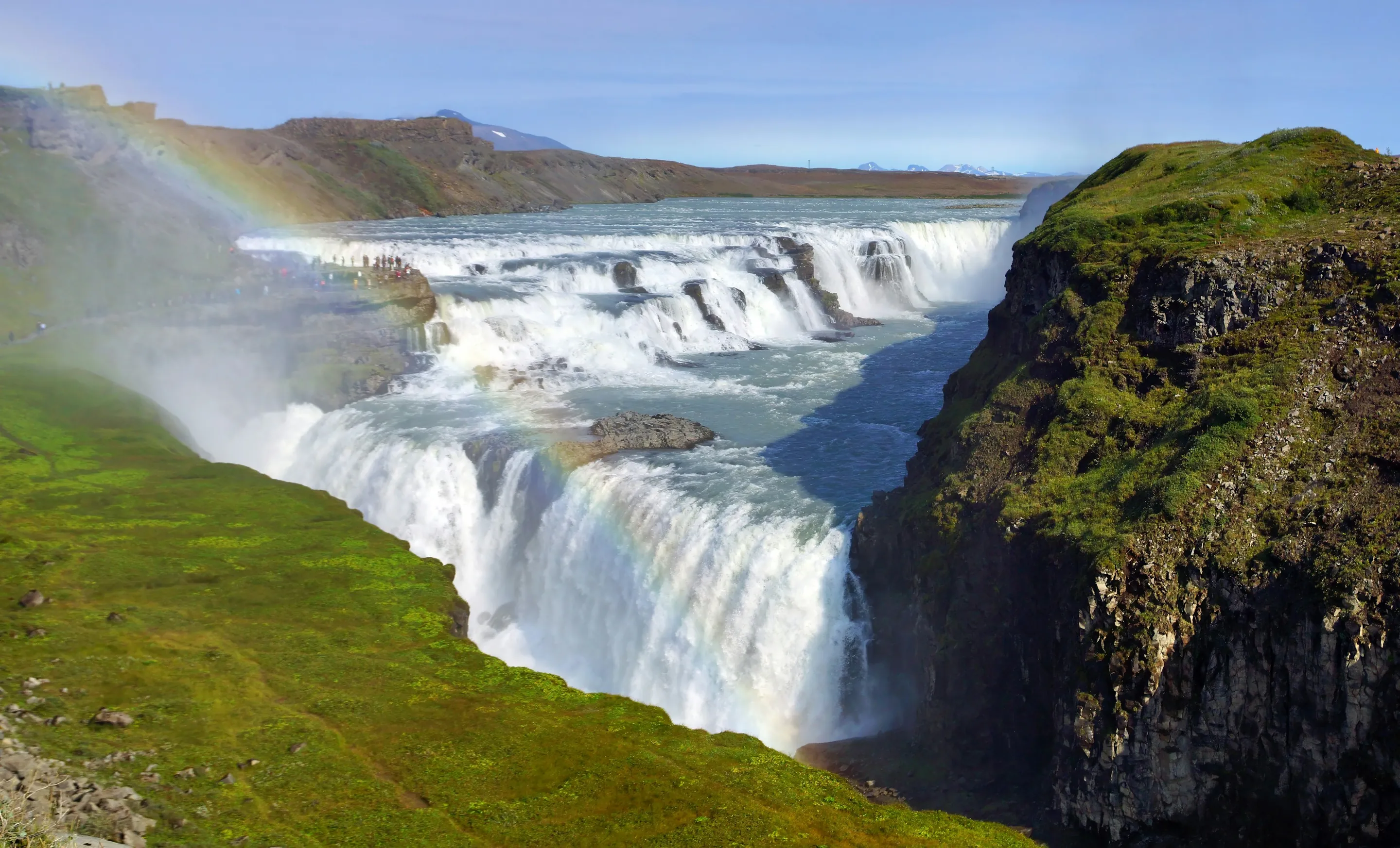 Gullfoss waterfall pouring into its canyon, a rainbow in the spray